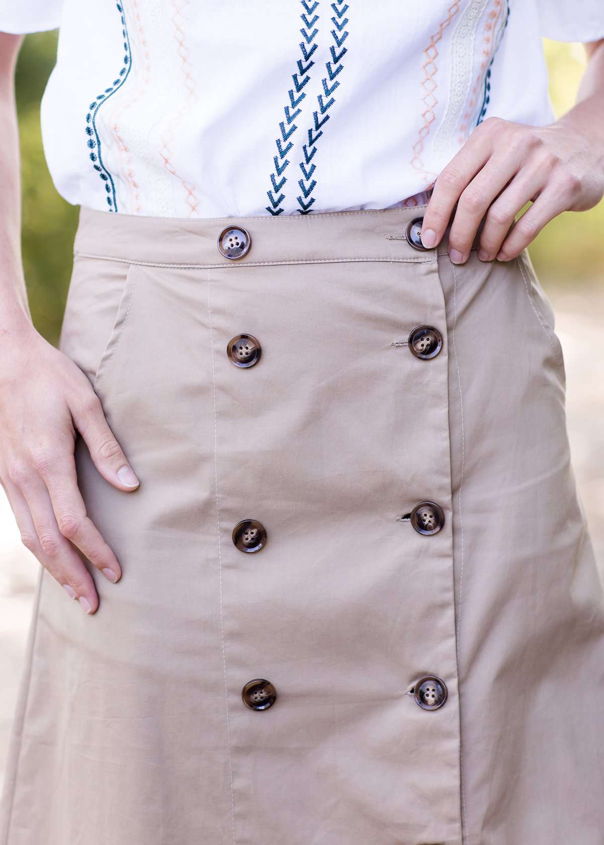 Taupe midi length skirt with double buttons down the front.