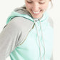 Woman wearing a mint and gray doublehood sweatshirt from ampersand avenue