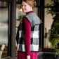 Woman wearing a sailor color, open front, black and white checker drape vest