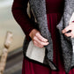 Woman wearing a sailor color, open front, black and white checker drape vest