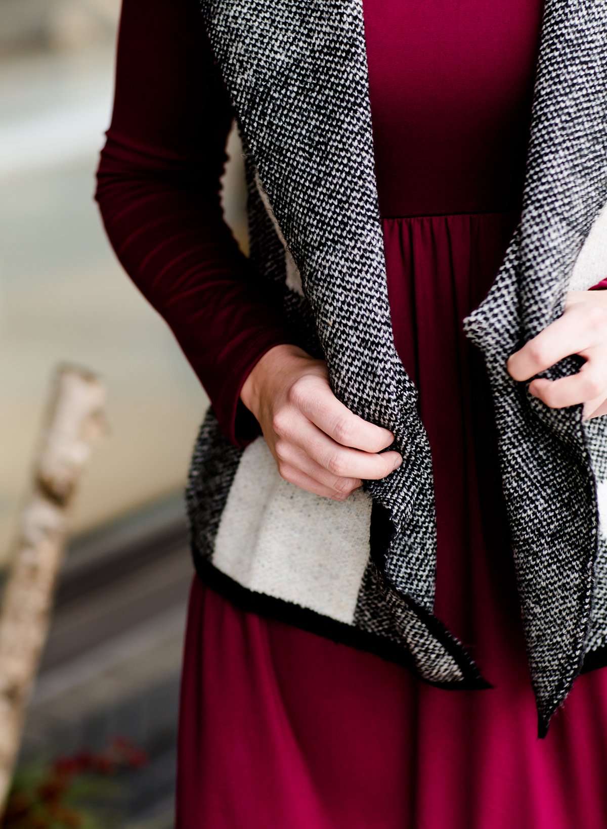 Woman wearing a sailor color, open front, black and white checker drape vest