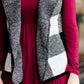 Woman wearing a sailor color, open front, black and white checker drape vest