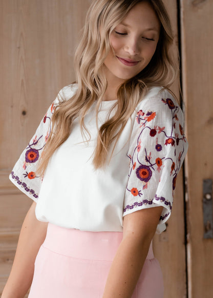 Fully lined you do not need to layer with this top with embroidered floral sleeves.