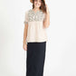 Woman wearing a blush embroidered bohemian style top