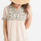 Woman wearing a blush embroidered bohemian style top