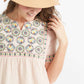 Woman wearing a blush embroidered bohemian style top