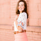 White top with multi color floral embroidered knit sleeves