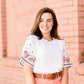 White top with multi color floral embroidered knit sleeves