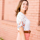 White top with multi color floral embroidered knit sleeves