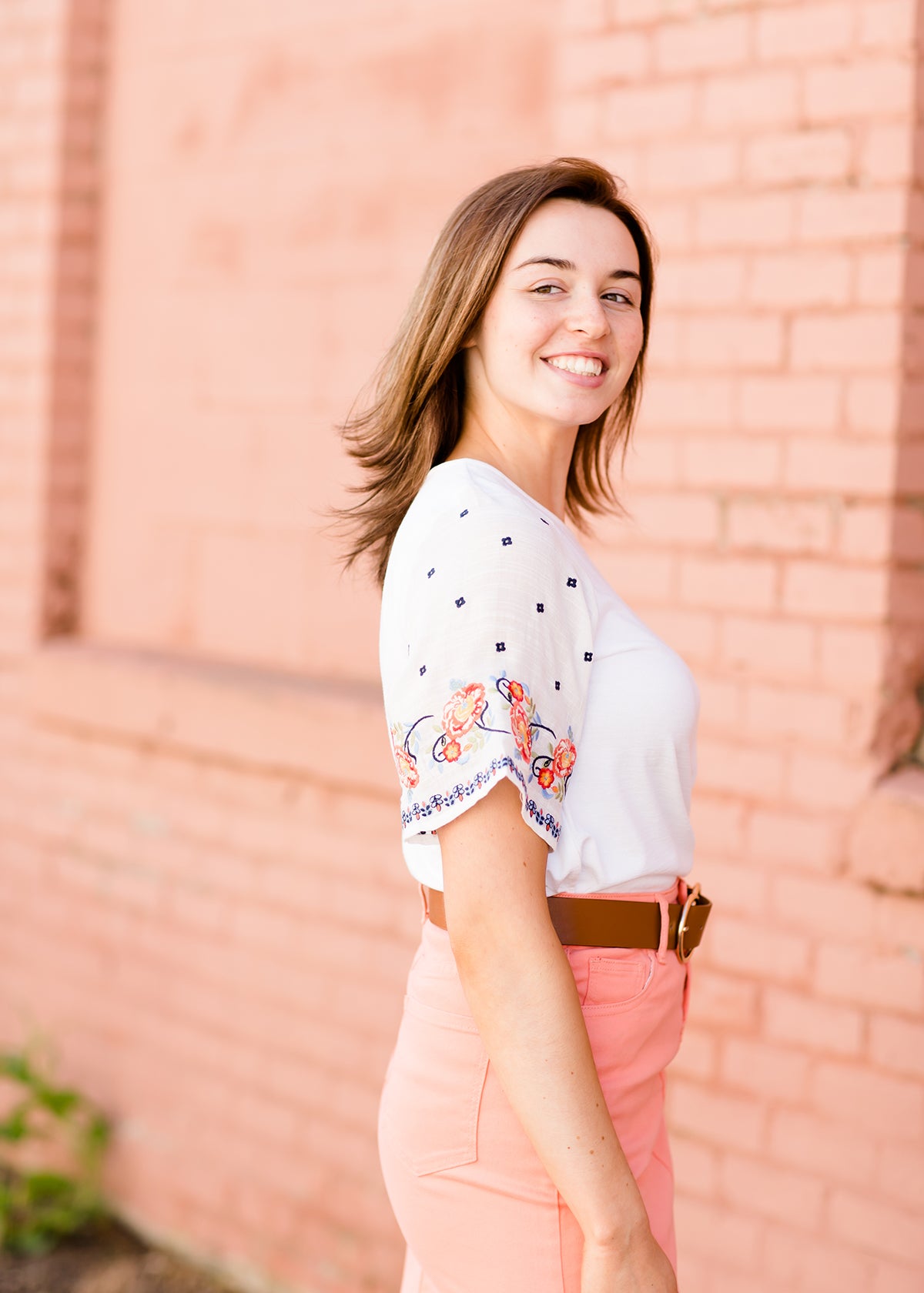 White top with multi color floral embroidered knit sleeves
