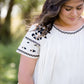 oatmeal colored flowy embroidered midi dress