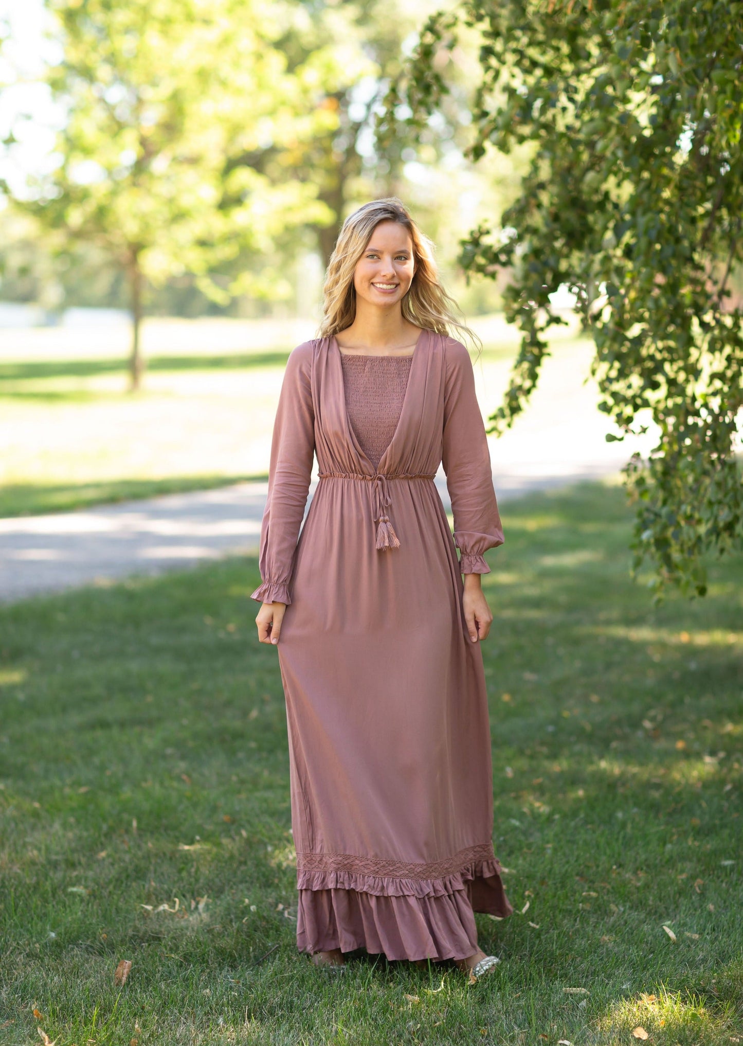 The Eve is an Inherit Design that is nursing friendly, has non functioning tie waist with tassels and is fully lined n a beautiful dusty mauve color. It is long sleeves and is a true maxi dress.
