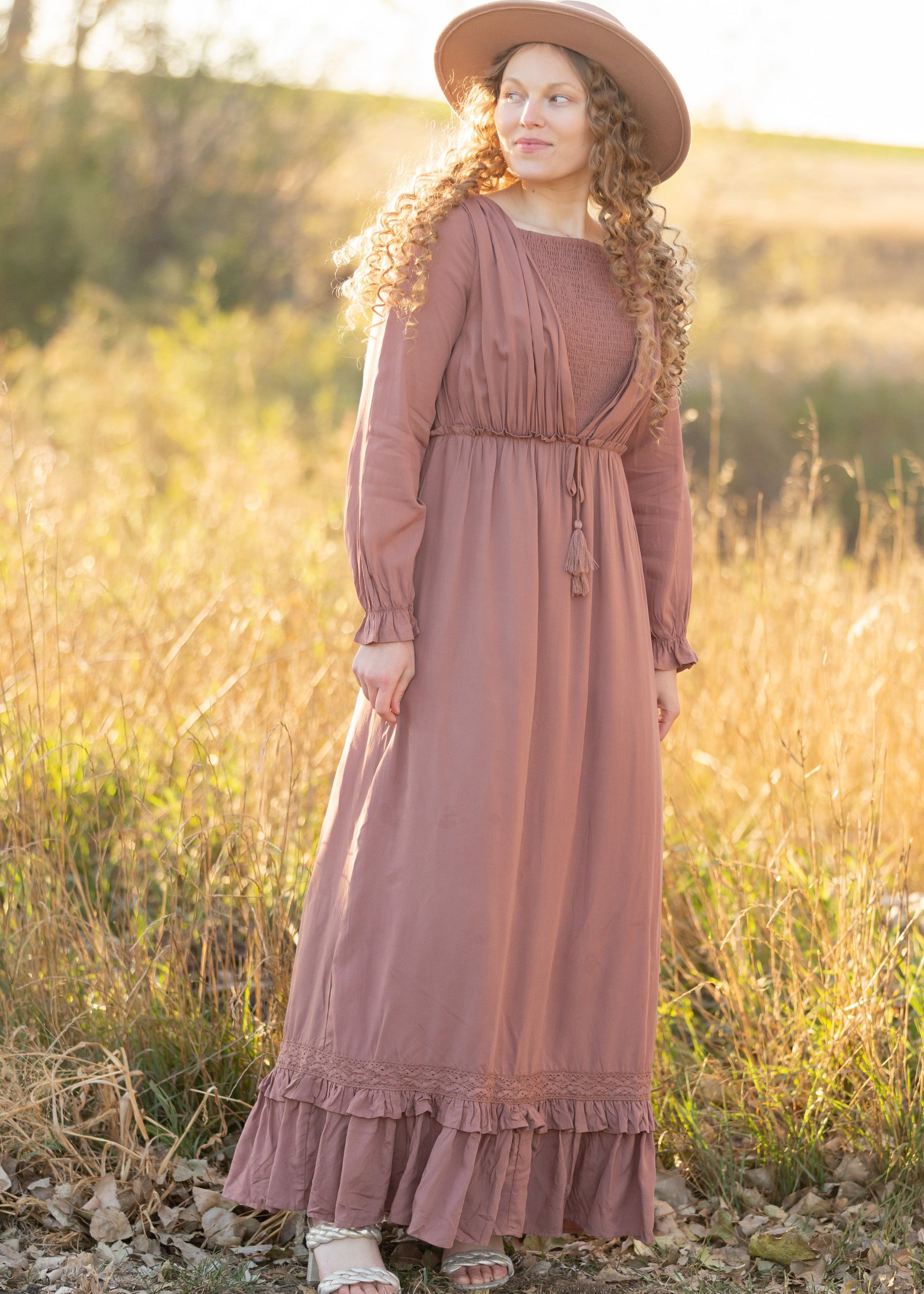 The Eve is an Inherit Design that is nursing friendly, has non functioning tie waist with tassels and is fully lined n a beautiful dusty mauve color. It is long sleeves and is a true maxi dress.