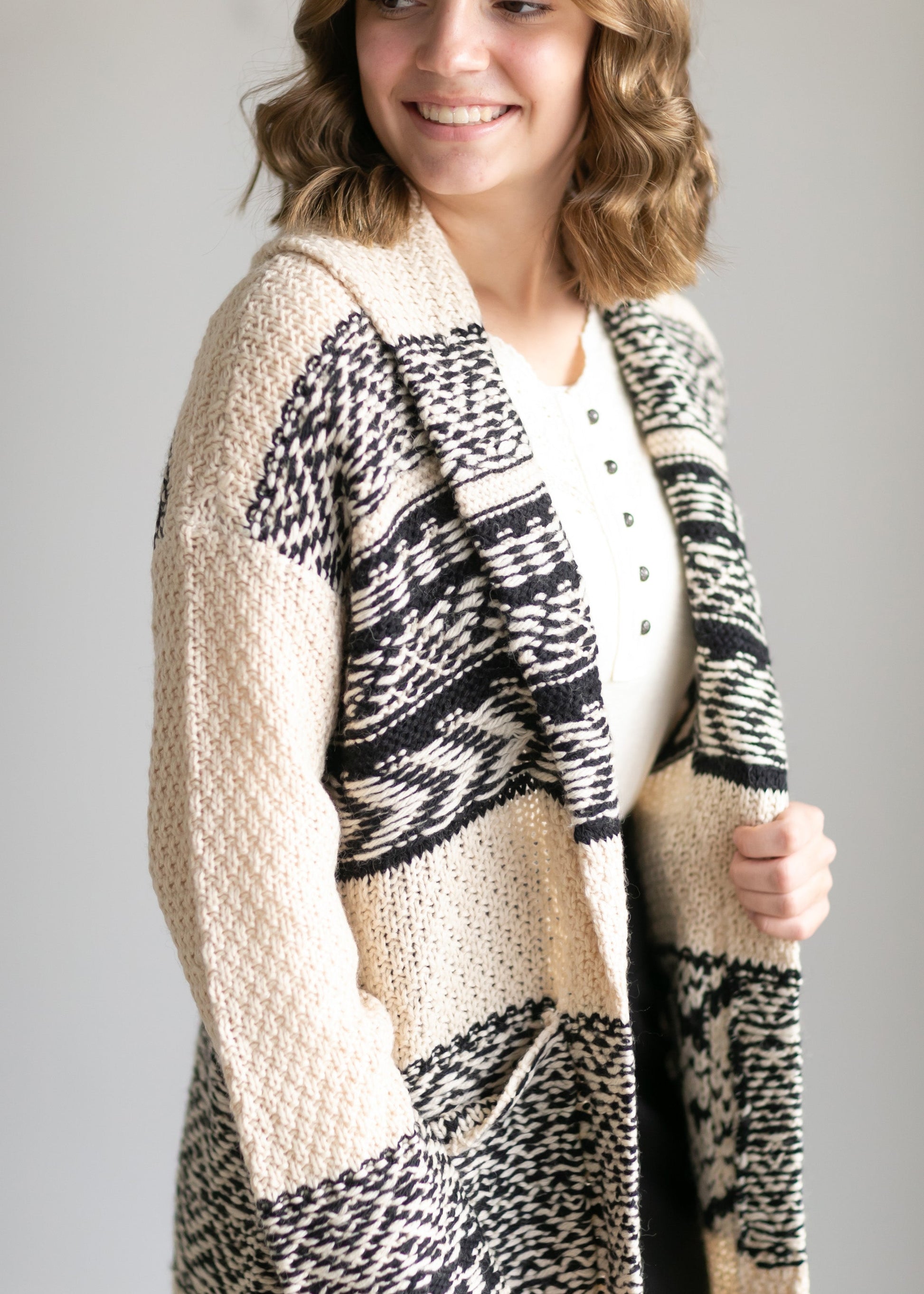 The Fair Isle Open Front Coatigan by Lucky Brand is the perfect indoor/outdoor layer! These open front cardigans have a thick knit pattern in black + tan or gray + white. Designed with a shawl collar, and large front pockets! They can be worn as a coat or a cardigan and have an open front style that will look great with all the things!