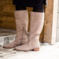 These are cow split suede tall riding boots. The have a stacked heel and feature a size zip on the 16" shaft of the riding boot. These boots are being word with a modest midi dress!