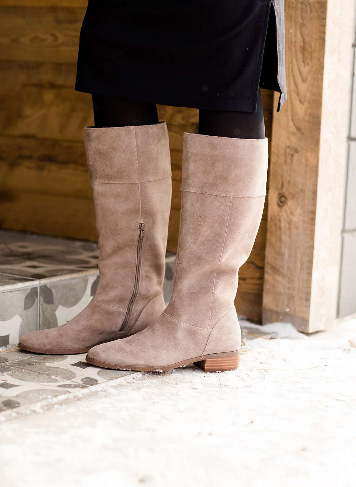 These are cow split suede tall riding boots. The have a stacked heel and feature a size zip on the 16" shaft of the riding boot. These boots are being word with a modest midi dress!