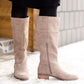 These are cow split suede tall riding boots. The have a stacked heel and feature a size zip on the 16" shaft of the riding boot. These boots are being word with a modest midi dress!