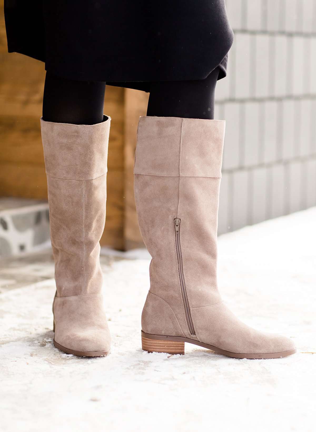 These are cow split suede tall riding boots. The have a stacked heel and feature a size zip on the 16" shaft of the riding boot. These boots are being word with a modest midi dress!