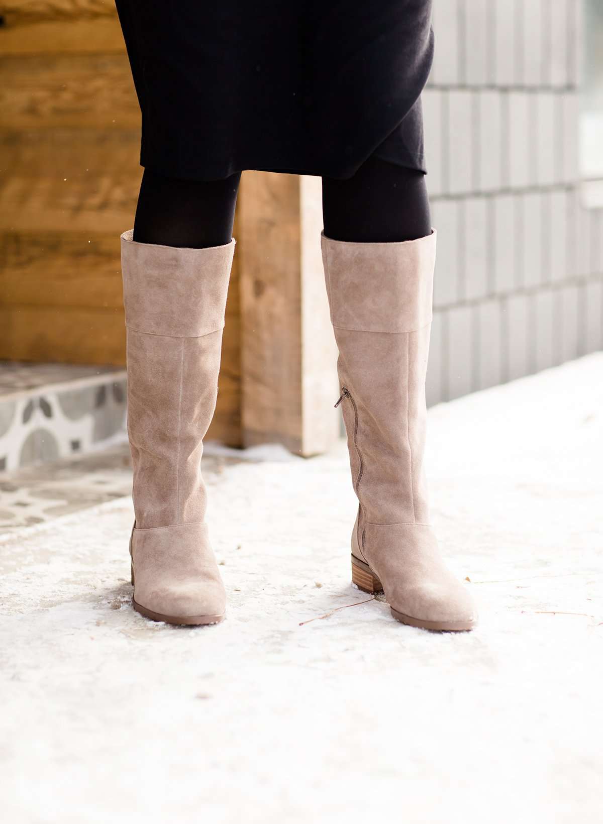 These are cow split suede tall riding boots. The have a stacked heel and feature a size zip on the 16" shaft of the riding boot. These boots are being word with a modest midi dress!