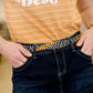 black, white and yellow bandana scarf as a belt