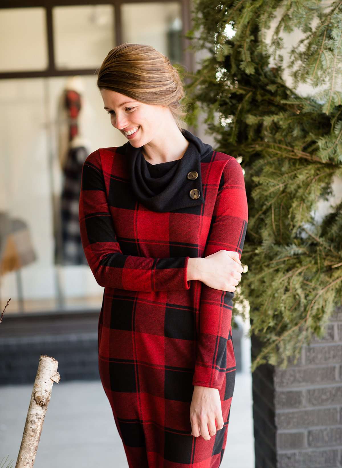 Woman wearing a black and red buffalo check, flannel shift dress at Inherit Clothing Company.
