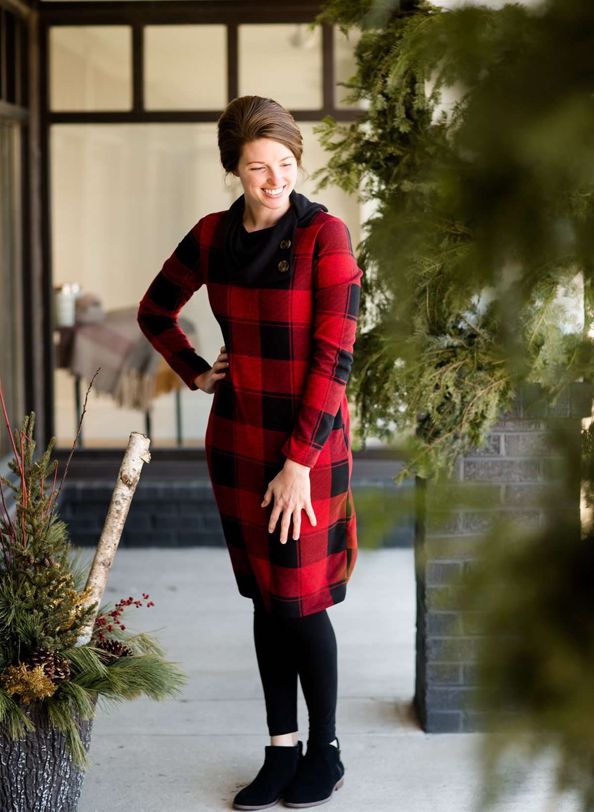 Woman wearing a black and red buffalo check, flannel shift dress at Inherit Clothing Company.