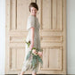 woman wearing a modest tan and floral smocked midi dress