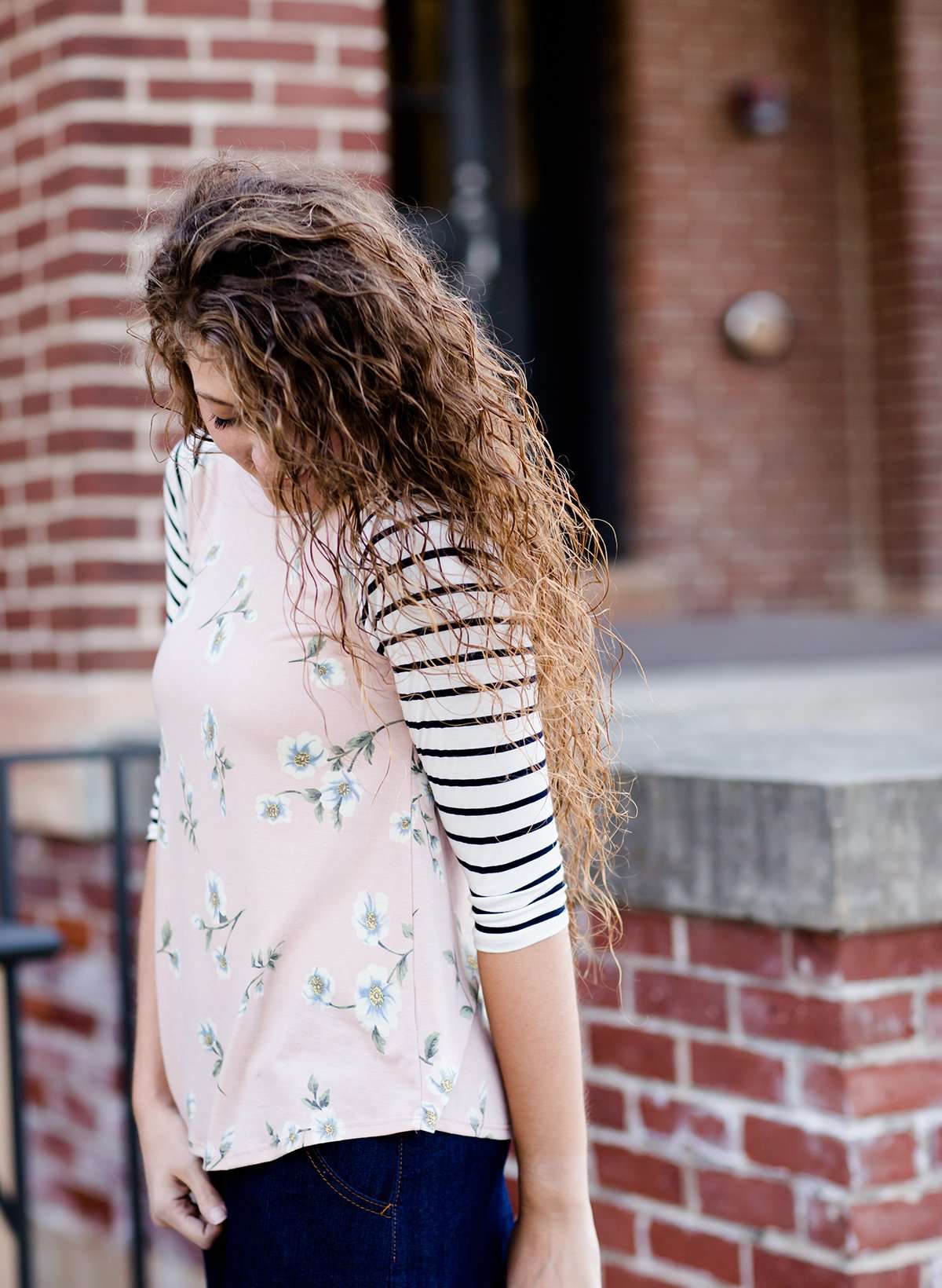 Woman wearing a modest baseball tee with black striped arms and a blush floral body along with her daughter making it a mommy and me modest raglan style tee shirt