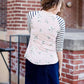 Woman wearing a modest baseball tee with black striped arms and a blush floral body along with her daughter making it a mommy and me modest raglan style tee shirt