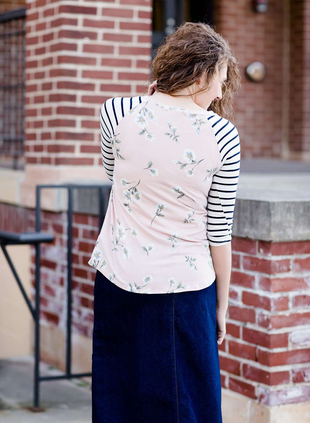 Woman wearing a modest baseball tee with black striped arms and a blush floral body along with her daughter making it a mommy and me modest raglan style tee shirt