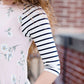 Woman wearing a modest baseball tee with black striped arms and a blush floral body along with her daughter making it a mommy and me modest raglan style tee shirt