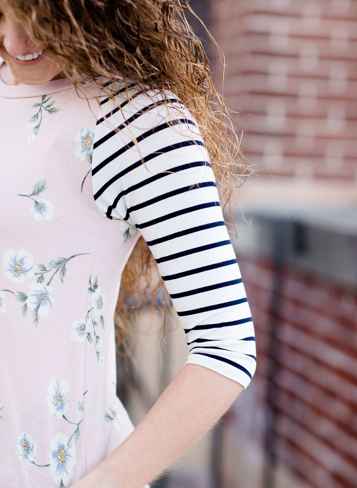 Woman wearing a modest baseball tee with black striped arms and a blush floral body along with her daughter making it a mommy and me modest raglan style tee shirt