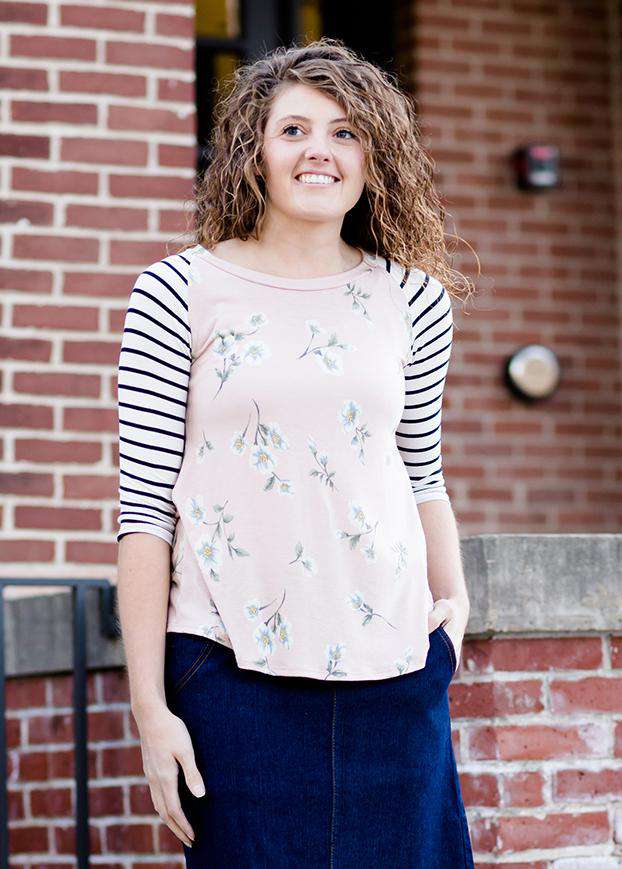Woman wearing a modest baseball tee with black striped arms and a blush floral body along with her daughter making it a mommy and me modest raglan style tee shirt