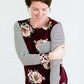 Woman wearing a stripe and floral contrast long sleeve tee with a pocket.