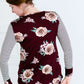 Woman wearing a stripe and floral contrast long sleeve tee with a pocket.