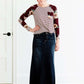 Woman wearing a modest burgandy floral and stripe long sleeve top with a twist front hem.