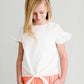 Girl wearing a modest ivory colored tie front top with flutter sleeves