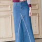 woman wearing an a-line modest long denim skirt with fringe detail and no slit