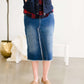 Fringe front below the knee jean skirt with vintage fading and a raw hem.