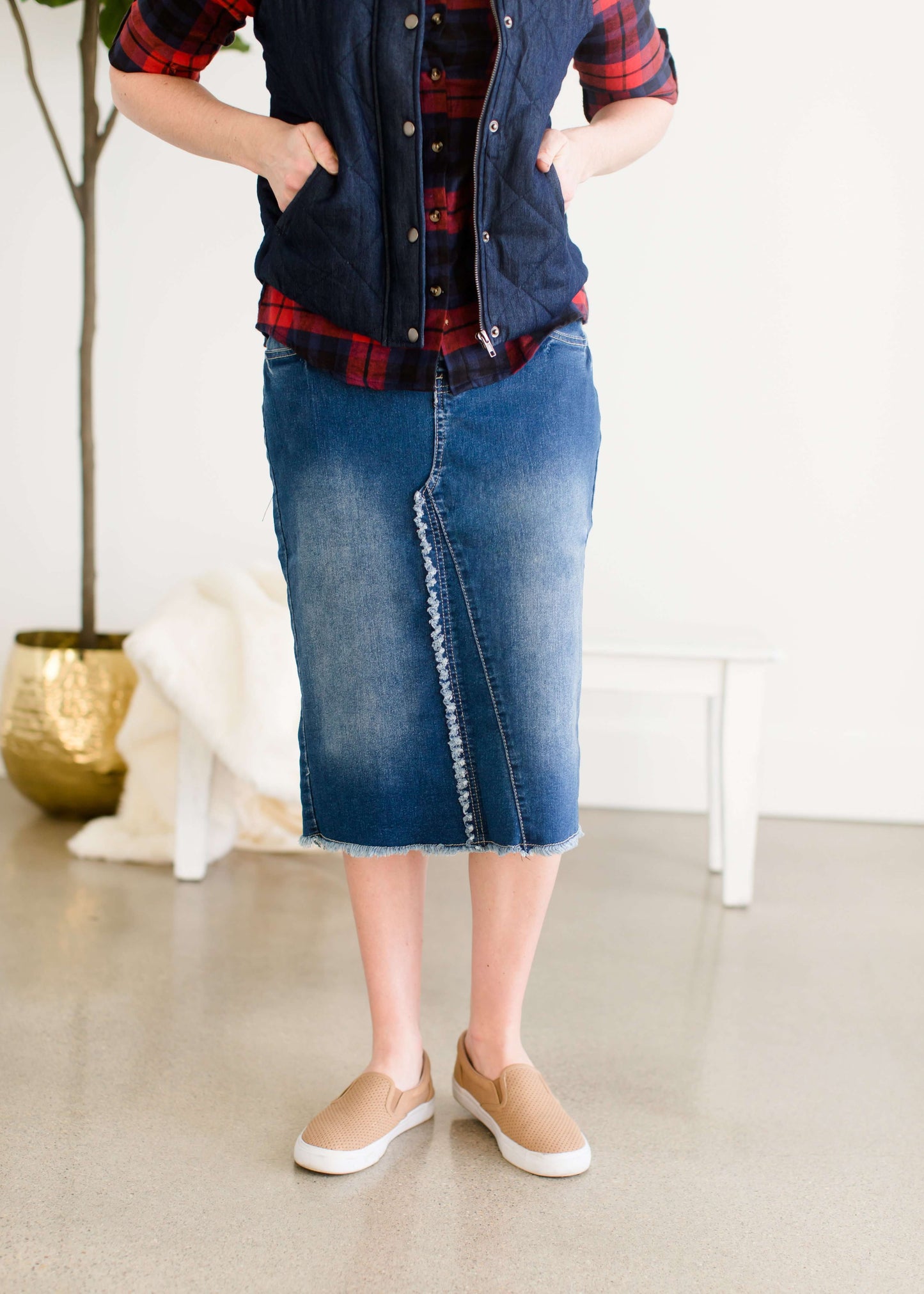 Fringe front below the knee jean skirt with vintage fading and a raw hem.