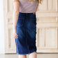 modest woman wearing a fringe dark denim below the knee skirt