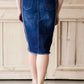 modest woman wearing a fringe dark denim below the knee skirt