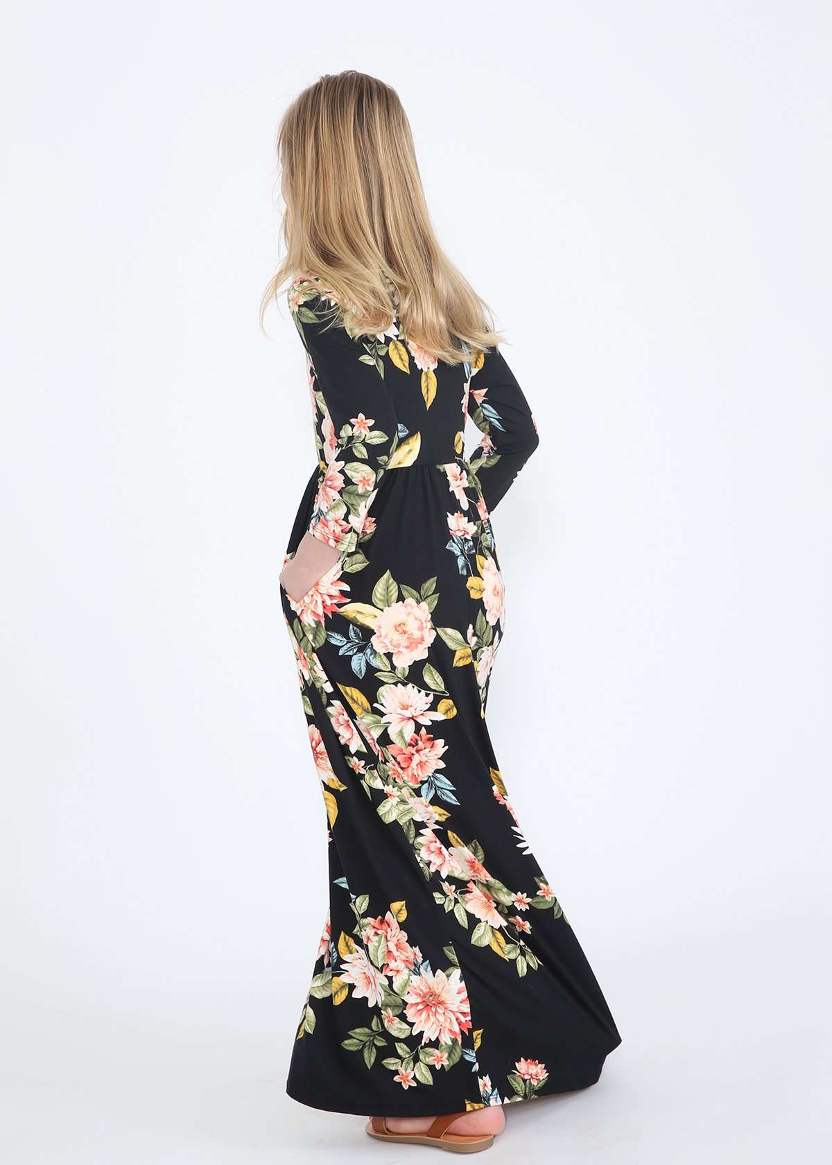 young girl wearing a modest black maxi dress with flowers on it
