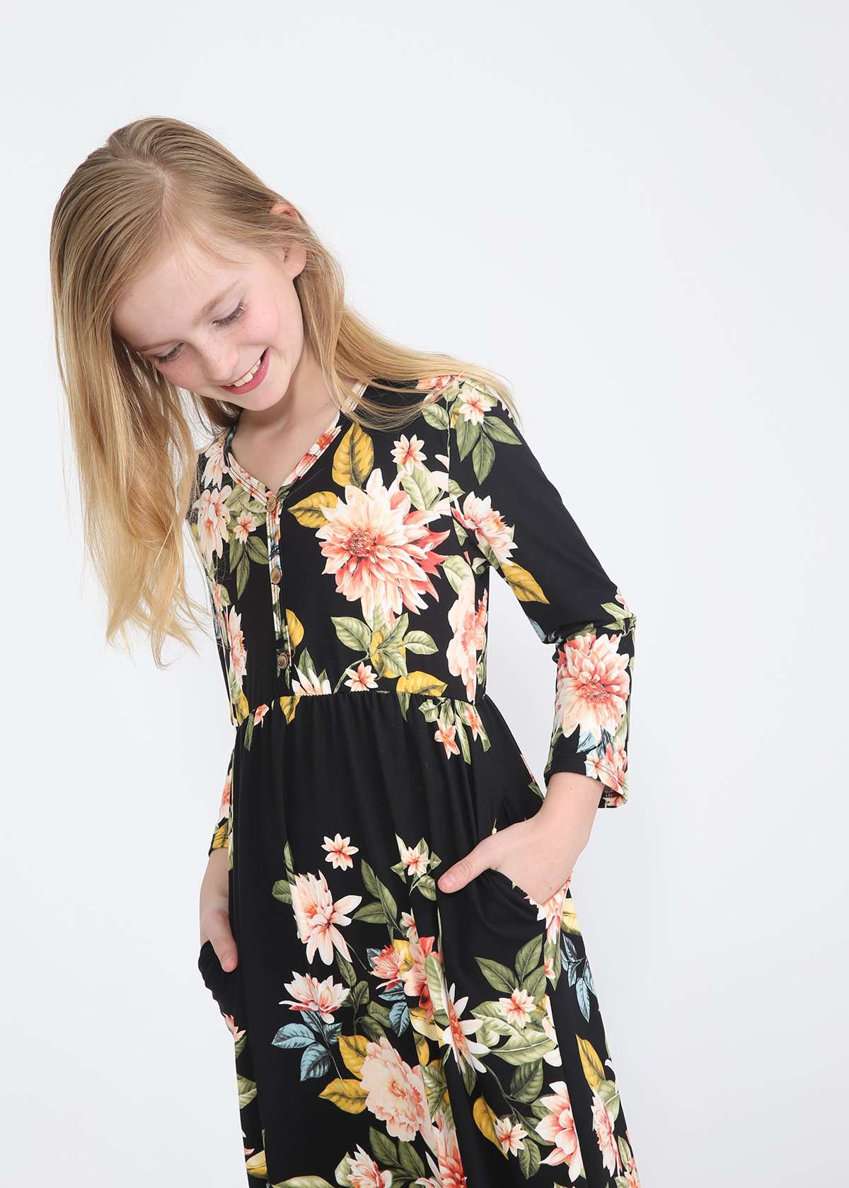 young girl wearing a modest black maxi dress with flowers on it