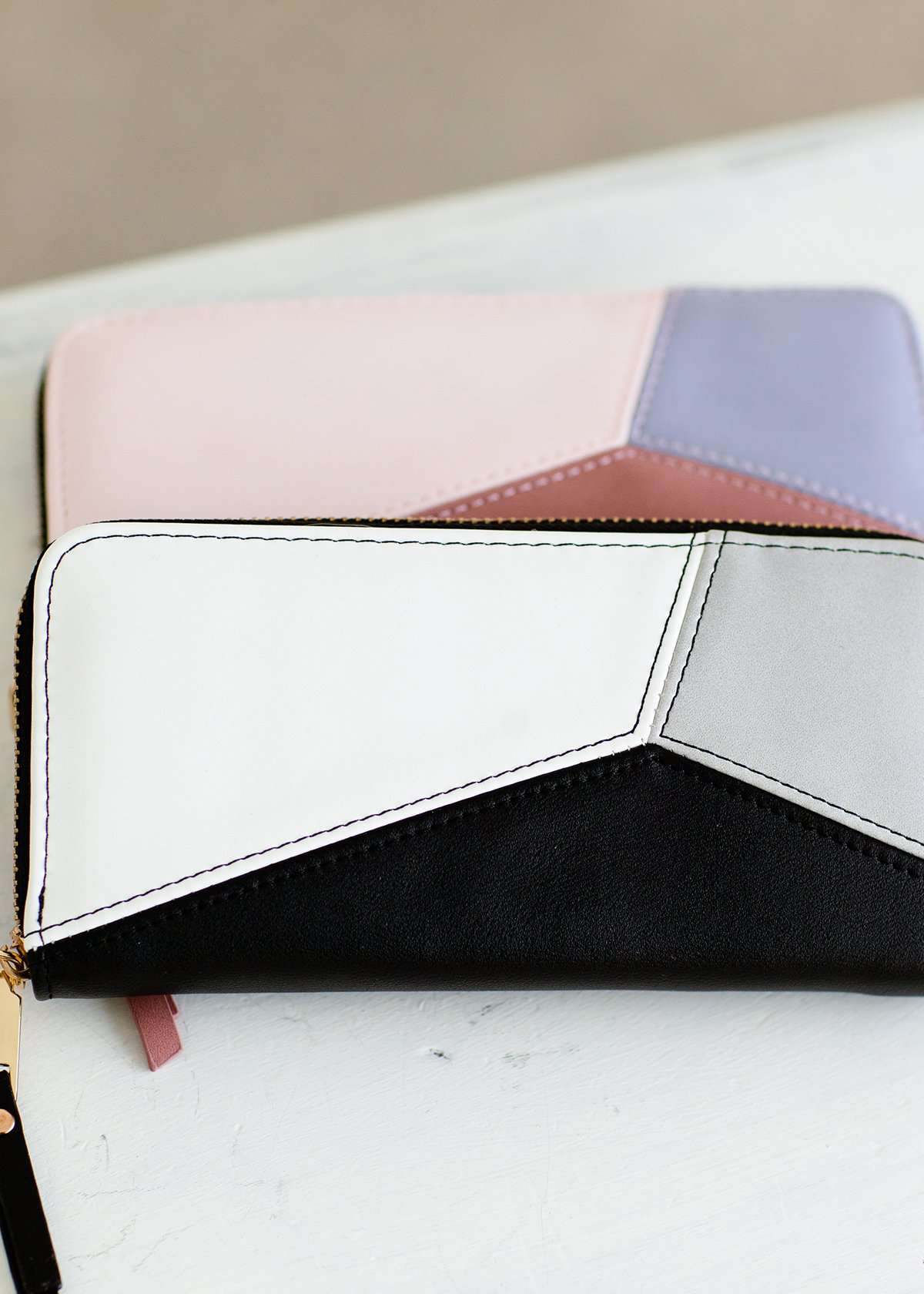 Geomeric Minimalist Wallet with zipper closure and bill divider. Black, white, peach, mauve and mint colors available.