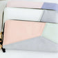 Geomeric Minimalist Wallet with zipper closure and bill divider. Black, white, peach, mauve and mint colors available.