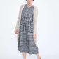woman wearing a navy and white gingham print midi dress