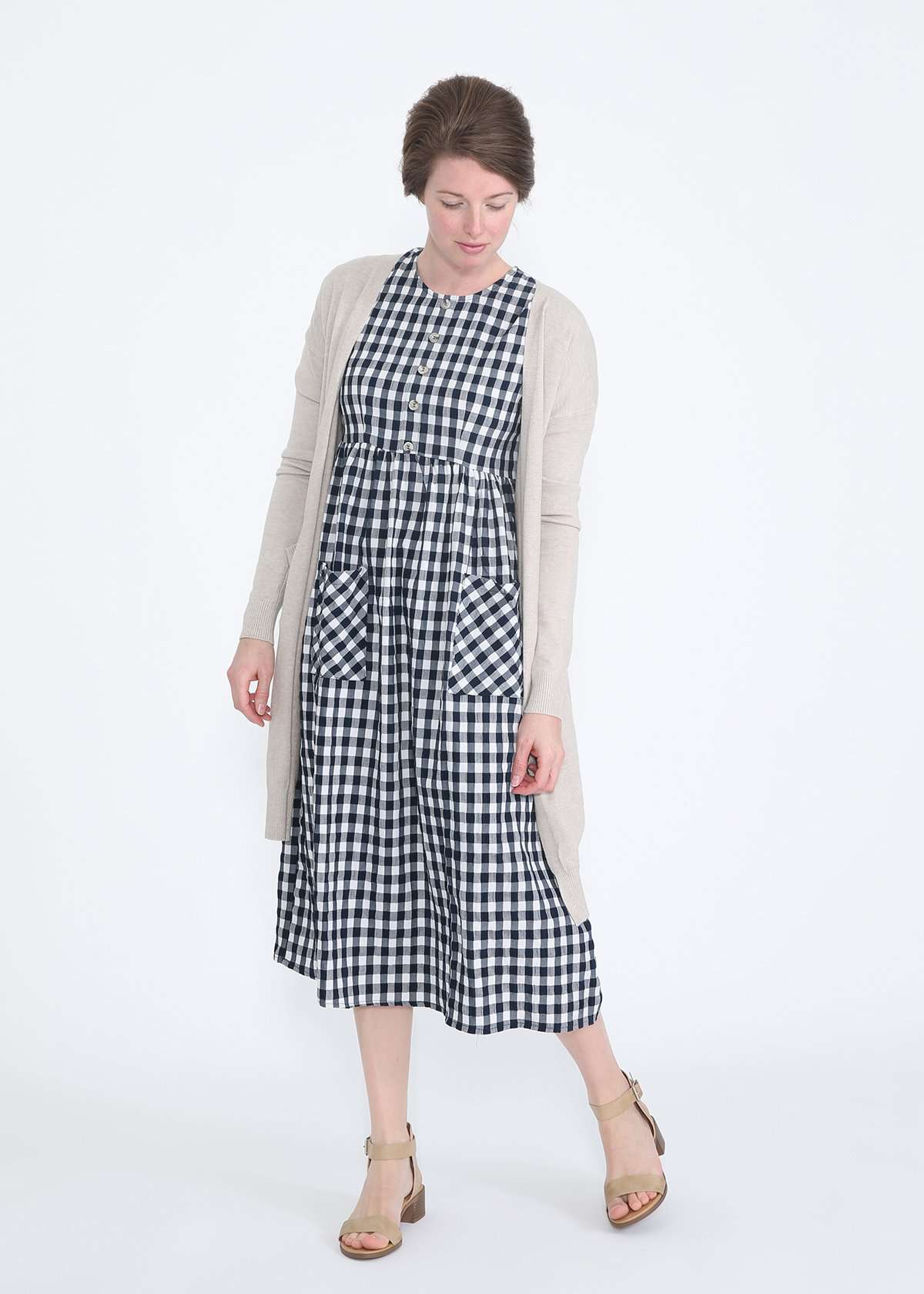 woman wearing a navy and white gingham print midi dress