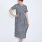 woman wearing a navy and white gingham print midi dress