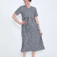 woman wearing a navy and white gingham print midi dress